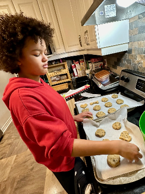 Our sweet Sophia baking delicious cookies for our supporters :-)